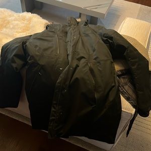 Parka style North face Dark Green Winter Coat. Feathered down insulated.